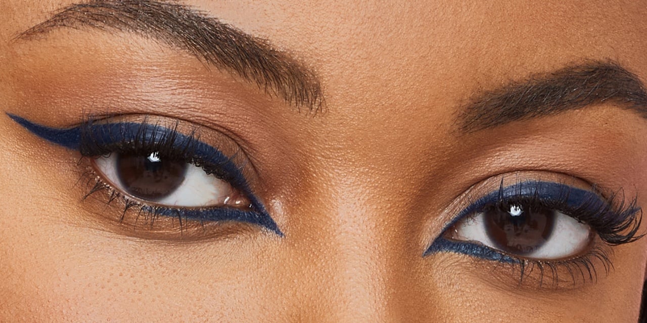 Siren Eyeliner look created using a blue liquid eyeliner on dark brown eyes